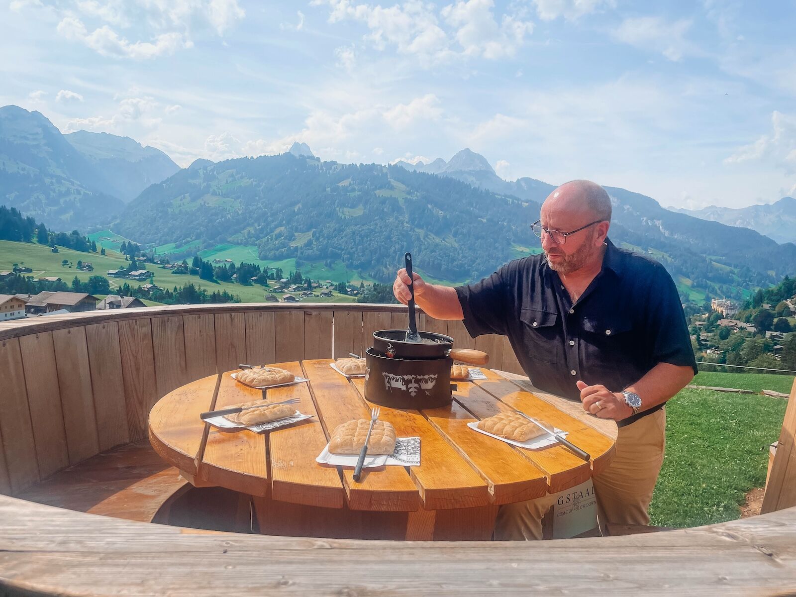 rene-stirring-fondue-with-scenery-behind