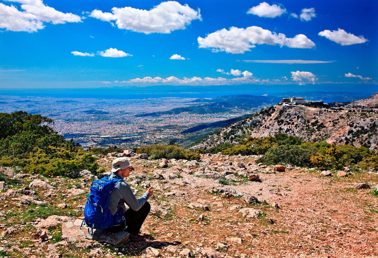 Hiker-enjoying-the-view-of-Athens-from-Parnitha-mountain Hiker-enjoying-the-view-of-Athens-from-Parnitha-mountain